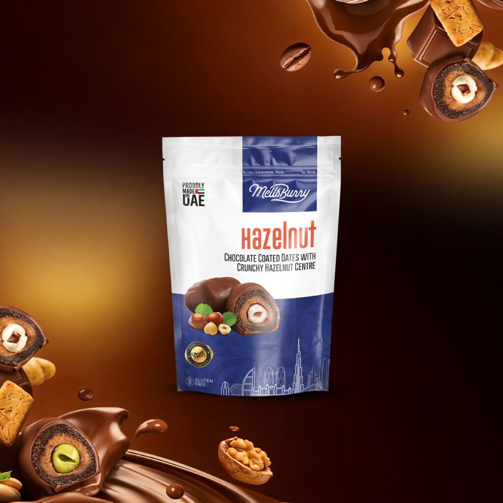 MellsBurry Hazelnut chocolate-coated dates packaging displayed against a rich chocolate-themed background. The premium pouch features chocolate-covered dates with a crunchy hazelnut center, highlighted by images of whole and sliced dates, hazelnuts, and flowing chocolate splashes. The product is proudly made in the UAE and gluten-free, representing a luxury confectionery snack crafted with premium dates and high-quality chocolate. Decorative chocolate-coated stuffed dates and nuts surrounding the package emphasize indulgence, gourmet gifting, and premium Middle Eastern sweets.